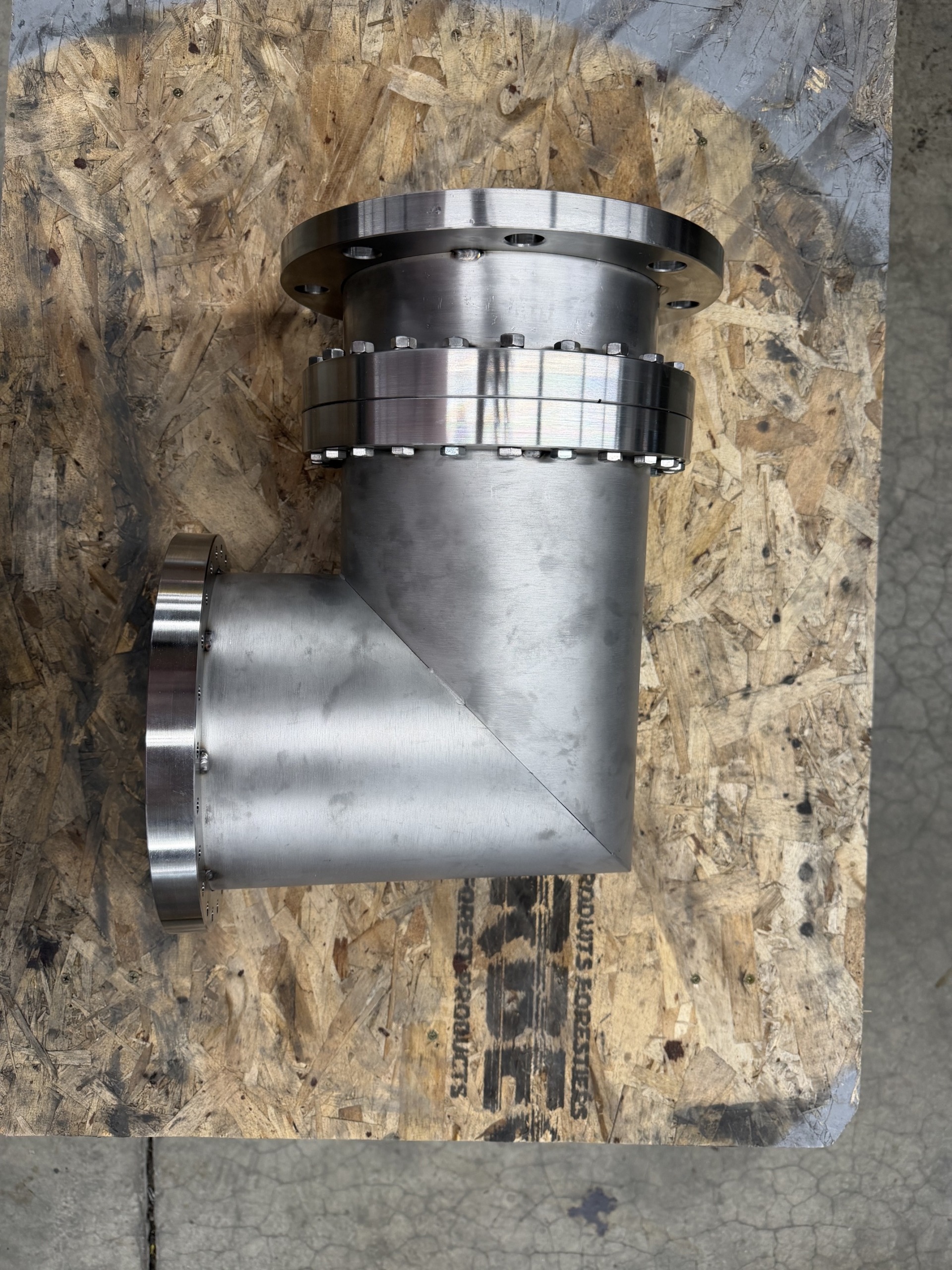 Custom flange adapter used to connect a diffusion pump to a vacuum coating system