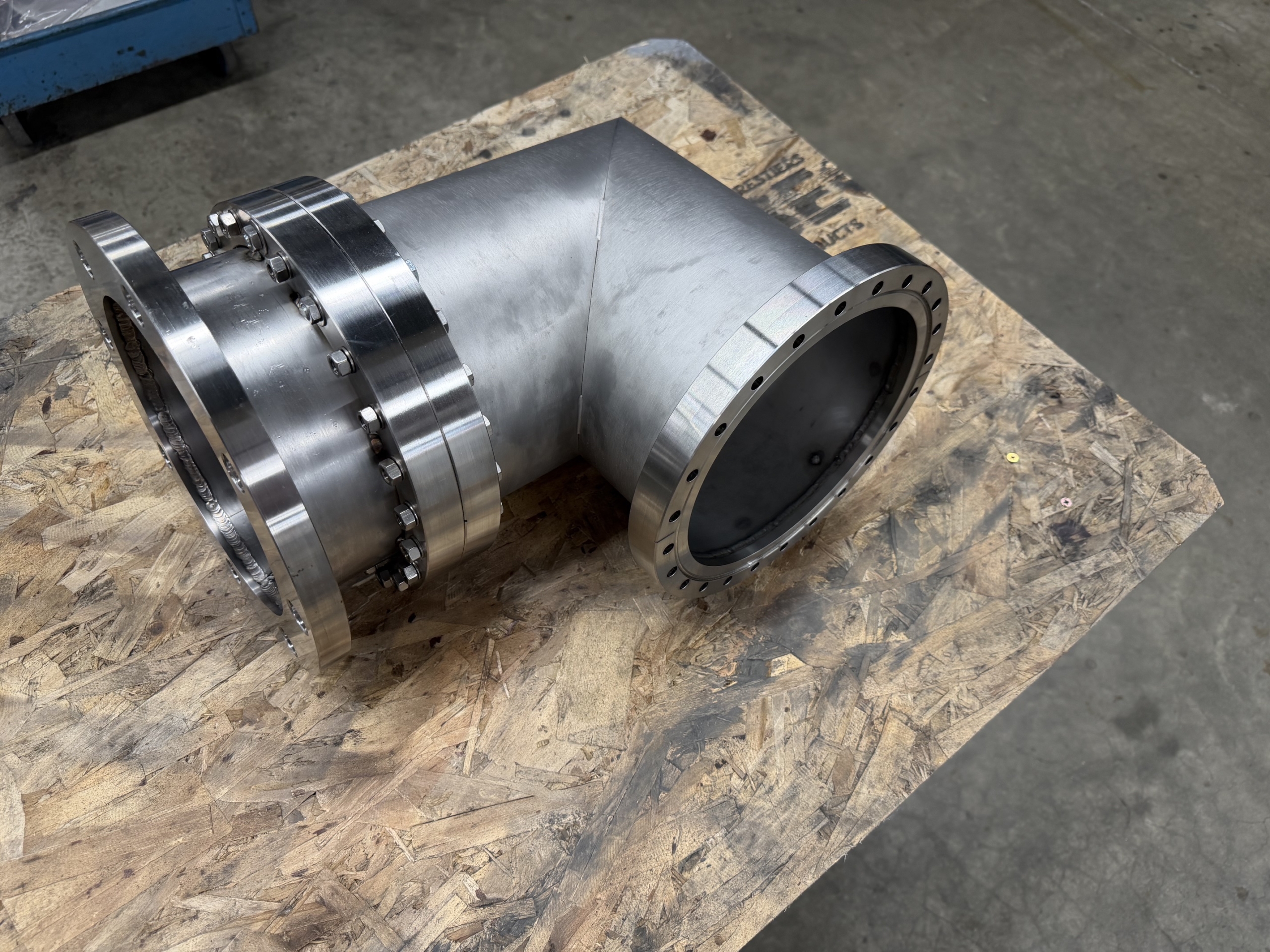 Close-up of flange connection hardware for integrating a pump with a vacuum coating chamber