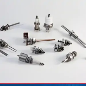 a variety of component parts for vacuum systems on a white surface